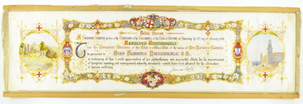 A long certificate with an ornate frame and text inside, announcing the awarding of the Freedom of the City to Florence Nightingale. There are two images on the certificate, the left image is a drawing of Nightingale's childhood home in Derbyshire and the right image is of Scutari Hospital.